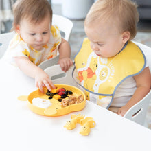 Load image into Gallery viewer, Two toddlers enjoy fruit and waffles from a yellow plate at a white table, with Bumkins Silicone Chewtensils®: Winnie The Pooh nearby.
