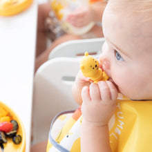 Load image into Gallery viewer, Close-up of a baby in yellow bib chewing on a Bumkins Silicone Chewtensils®: Winnie The Pooh.
