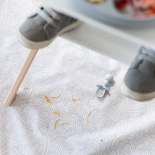 Load image into Gallery viewer, A Bumkins Silicone Chewtensils®: Gray sits on a beige mat with spaghetti under a high chair, with toddler shoes blurred in the foreground
