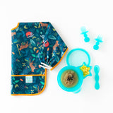 Bumkins Silicone Chewtensils®: Blue Jelly lay by a blue bowl with applesauce, a blue spoon, and a folded blue bib on a white background.