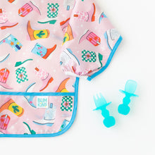 Load image into Gallery viewer, Close-up of Bumkins Sleeved Bib: Boots on a white background next to blue transparent toddler utensils.
