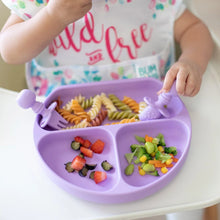 Load image into Gallery viewer, Close-up of a child in a high chair eating pasta and veggies from a purple divided plate with Bumkins Silicone Chewtensils®: Lavender.
