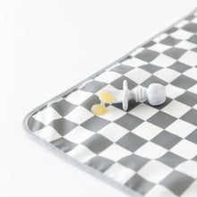 Load image into Gallery viewer, A Bumkins Silicone Chewtensils®: Marble lays atop a gray &amp; white checkered mat on a white background with applesauce on top.
