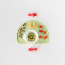 Load image into Gallery viewer, Bumkins Silicone Chewtensils®: Red is paired with Silicone Sensory Placemat: Sage and First Feeding Set: Vanilla Sprinkle on a white background.
