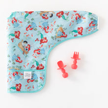 Load image into Gallery viewer, A colorful baby bib with Ariel is paired with Bumkins Silicone Chewtensils®: Red on a white background.

