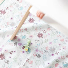 Load image into Gallery viewer, A Bumkins Silicone Chewtensils®: Sage with applesauce lays on a floral mat underneath a high chair with a baby's foot visible.
