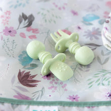 Load image into Gallery viewer, Close-up of Bumkins Silicone Chewtensils®: Sage laying on a purple floral bib; one lays face-down, showing sensory bumps on the back.
