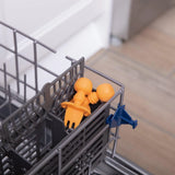 Bumkins Silicone Chewtensils®: Tangerine  sits in the utensil compartment of an open dishwasher.
