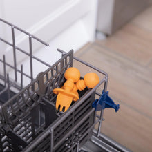 Load image into Gallery viewer, Bumkins Silicone Chewtensils®: Tangerine  sits in the utensil compartment of an open dishwasher.
