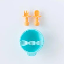 Load image into Gallery viewer, Bumkins Silicone Chewtensils®: Tangerine sit above a blue bowl and spoon set on a white background.
