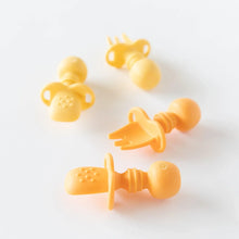 Load image into Gallery viewer, Bumkins Silicone Chewtensils®: Tangerine sits near a set of yellow utensils on a white background.
