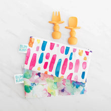 Load image into Gallery viewer, Bumkins Silicone Chewtensils®: Tangerine sits above two colorful waterproof pouches on a marble background.
