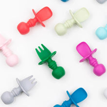 Load image into Gallery viewer, A Bumkins Silicone Chewtensils®: Jade lays among other silicone toddler utensils on a white background.
