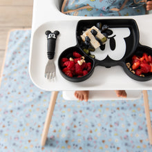 Load image into Gallery viewer, Boy in high chair wears a Mickey+Minnie bib, uses a Mickey fork and grip dish, sitting atop a matching Sunny Side Up splat mat.
