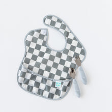 Load image into Gallery viewer, Bumkins Spoon + Fork: Gray lays near a checkered bib on a white background.
