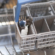 Load image into Gallery viewer, Bumkins Spoon + Fork: Gray sits in the utensil compartment of an open dishwasher.
