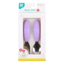 Load image into Gallery viewer, Bumkins Spoon + Fork: Lavender is shown in a white packaging box with a clear front window displaying the set of utensils.
