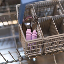 Load image into Gallery viewer, Bumkins Spoon + Fork: Lavender sits in the utensil compartment of an open dishwasher.
