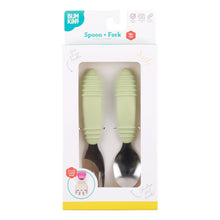 Load image into Gallery viewer, Bumkins Spoon + Fork: Sage is shown in a white packaging box with a clear front window displaying the set of utensils.
