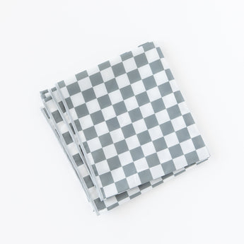 A folded Bumkins Splat Mat: Charcoal Check lays on a white background.