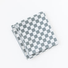 Load image into Gallery viewer, A folded Bumkins Splat Mat: Charcoal Check lays on a white background.
