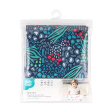 Load image into Gallery viewer, Bumkins Splat Mat: Animal Prints is shown folded in plastic packaging bag with a hanger and cardboard insert.
