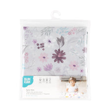 Load image into Gallery viewer, Bumkins Splat Mat: Floral is shown folded in plastic packaging bag with a hanger and cardboard insert.
