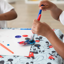 Load image into Gallery viewer, Close-up of two kids painting on paper on Bumkins Splat Mat: Mickey Mouse.
