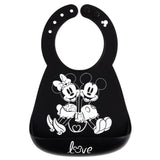 Bumkins Silicone Bib: Mickey + Minnie Mouse, made of black silicone, features a white illustration of Mickey and Minnie holding hands.