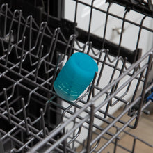 Load image into Gallery viewer, Bumkins Silicone Starter Cup: Blue sits in the top rack of an open dishwasher.

