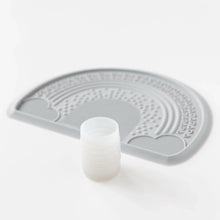 Load image into Gallery viewer, Bumkins Silicone Starter Cup: Gray sits in front of a gray silicone placemat on a white background.
