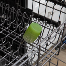 Load image into Gallery viewer, Bumkins Silicone Starter Cup: Sage sits in the top rack of an open dishwasher.
