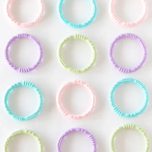 Load image into Gallery viewer, Multiple sets of Bumkins Silicone Teething Rings 4 Pack: Spring are neatly laid out on a white background.
