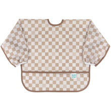Load image into Gallery viewer, Bumkins Sleeved Bib: Sand Check is made of tan checkered waterproof fabric with elastic cuffs; perfect for baby-led weaning.
