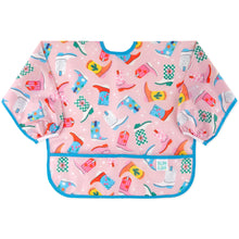 Load image into Gallery viewer, Bumkins Sleeved Bib: Boots features a vibrant cowboy boot print on pink waterproof fabric with blue trim and pocket.

