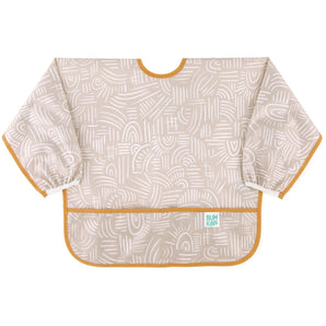 Bumkins Sleeved Bib: Wander is made of beige waterproof fabric with white abstract patterns, orange trim, front pocket, and elastic cuffs.