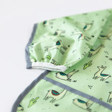 Load image into Gallery viewer, Close-up of Bumkins Sleeved Bib: Llamas on a white background, with focus on the elastic cuff on the sleeve.
