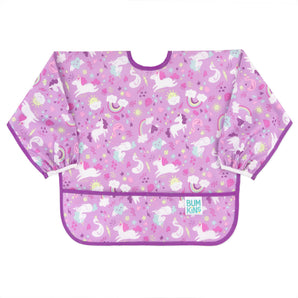 Bumkins Sleeved Bib: Unicorns is a long sleeved bib made of purple waterproof fabric with a unicorn and rainbow print.
