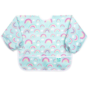 Bumkins Sleeved Bib: Rainbows is made of light blue waterproof fabric with a rainbow and cloud pattern, white trim, and front pocket.