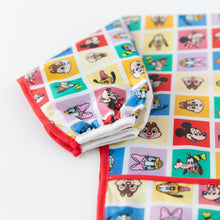 Load image into Gallery viewer, Close-up of Bumkins Sleeved Bib: Mickey &amp; Friends Check Mates on a white background, showcasing the white elastic cuff on the sleeve.
