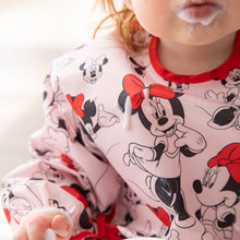 Load image into Gallery viewer, Close-up of a child with a messy mouth wearing a Bumkins Sleeved Bib: Minnie Mouse covered with yogurt drops.
