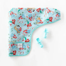 Load image into Gallery viewer, Bumkins Sleeved Bib: Ariel lays folded next to blue baby utensils on a white background.
