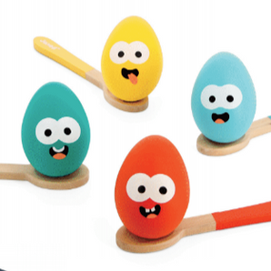 Janod Juratoys Egg and Spoon Race set includes colorful toy eggs with eyes and mouths on vibrant orange, yellow, teal, and blue spoons.