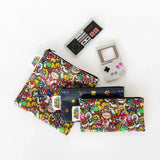 Colorful video game-themed pouches sit on a white background near Bumkins Silicone Teether: NES™ Controller and another teether.
