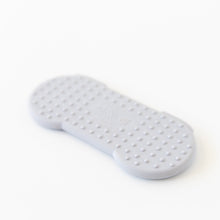 Load image into Gallery viewer, Bumkins Silicone Teether: Nintendo SNES™ Controller lays face down on a white background, showcasing the raised dots on the back.
