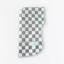 Load image into Gallery viewer, Bumkins Junior Bib: Charcoal Check is folded lengthwise on a white background.
