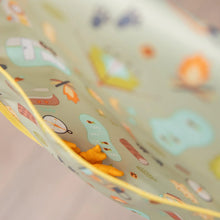 Load image into Gallery viewer, Close-up of orange snack crackers in the pocket of a Bumkins Junior Bib: Camp Gear.
