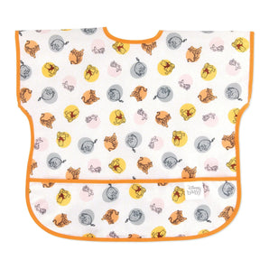 Bumkins Junior Bib: Winnie and Friends is made of white waterproof fabric with a colorful character design, orange trim, and front pocket.