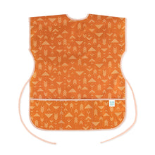 Load image into Gallery viewer, Bumkins Short-Sleeved Smock: Grounded features a white geometric pattern on orange waterproof fabric with an adjustable tie waist.

