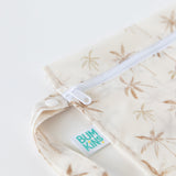 Close-up of Bumkins Wet Bag: Palm Daze, featuring a palm tree pattern and white zipper; a waterproof, eco-friendly choice.